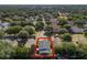 Aerial shot of a home with an enclosed pool, surrounded by mature trees and lush greenery at 2098 Carpathian Dr, Apopka, FL 32712