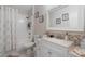 Modern bathroom featuring a shower-tub combo, a decorative mirror, and a sleek vanity for a spa-like experience at 2098 Carpathian Dr, Apopka, FL 32712