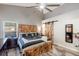 Spacious bedroom featuring wood accents, a ceiling fan, a window view, and ample storage for a comfortable living experience at 2098 Carpathian Dr, Apopka, FL 32712