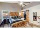 Spacious bedroom featuring wood accents, a ceiling fan, a window view, and ample storage for a comfortable living experience at 2098 Carpathian Dr, Apopka, FL 32712