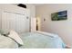 Bright bedroom with a closet, television, and soothing, comfortable bedding for a relaxing and restful atmosphere at 2098 Carpathian Dr, Apopka, FL 32712