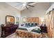 Spacious bedroom featuring wood accents, a ceiling fan, a window view, and ample storage for a comfortable living experience at 2098 Carpathian Dr, Apopka, FL 32712