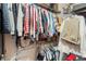 This walk-in closet is filled with clothing on racks and shelves at 2098 Carpathian Dr, Apopka, FL 32712