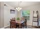 View of the dining room with picture window and wooden table, featuring light fixture at 2098 Carpathian Dr, Apopka, FL 32712
