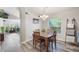 Dining room features a window, an elegant chandelier and wood-look flooring at 2098 Carpathian Dr, Apopka, FL 32712