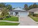 Charming single-story home with a well-manicured lawn, lovely landscaping, and an attached two-car garage at 2098 Carpathian Dr, Apopka, FL 32712