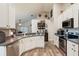 Open kitchen featuring stainless appliances and breakfast bar with view to living area at 2098 Carpathian Dr, Apopka, FL 32712