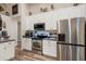 Kitchen featuring stainless steel appliances, white cabinets and gray countertop at 2098 Carpathian Dr, Apopka, FL 32712