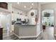 Modern kitchen featuring white cabinetry, updated appliances, counter seating, and open access to the living area at 2098 Carpathian Dr, Apopka, FL 32712