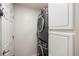 This laundry area includes a stacked washer and dryer unit and a white cabinet at 2098 Carpathian Dr, Apopka, FL 32712