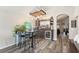Stylish living room featuring a home bar area with custom wooden bar and shelving, seating, and modern flooring at 2098 Carpathian Dr, Apopka, FL 32712