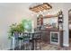 Stylish living room featuring a home bar area with custom wooden bar and shelving, seating, and modern flooring at 2098 Carpathian Dr, Apopka, FL 32712