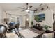 Inviting living room featuring comfortable seating, decor, and media center with views to the backyard patio at 2098 Carpathian Dr, Apopka, FL 32712
