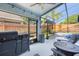 This screened-in patio features a Blackstone grill and furniture with a view of the pool at 2098 Carpathian Dr, Apopka, FL 32712