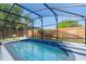 Inviting screened pool area with mature trees and a privacy fence at 2098 Carpathian Dr, Apopka, FL 32712
