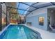 Screened pool with a bar area and beautiful blue tiling at 2098 Carpathian Dr, Apopka, FL 32712