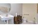 Half bathroom with stylish vanity, a round mirror, and convenient accessibility features at 211 Taylor Groves Dr, Lake Wales, FL 33853