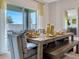 Dining room with a long wooden table set for a meal, next to glass patio doors at 211 Taylor Groves Dr, Lake Wales, FL 33853