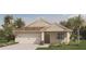 Charming one-story home featuring a two-car garage, neutral exterior, and well-manicured landscaping at 211 Taylor Groves Dr, Lake Wales, FL 33853
