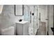 Modern bathroom featuring marble walls, glass shower, and updated fixtures at 245 W George Ave, Maitland, FL 32751