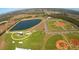 Expansive aerial view featuring lush baseball fields and a picturesque lake, creating a vibrant recreational atmosphere at 2658 Palmetto Ridge Cir, Apopka, FL 32712