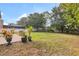 Spacious backyard featuring a garden, grass and white fencing at 2658 Palmetto Ridge Cir, Apopka, FL 32712