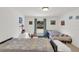 Bright bedroom features two beds with quilts and a window with a view of the outdoors at 2658 Palmetto Ridge Cir, Apopka, FL 32712