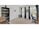 Cozy bedroom with large windows, dark curtains, and a filled bookcase at 2658 Palmetto Ridge Cir, Apopka, FL 32712
