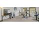 Spacious bonus room features multiple workstations, refrigerator, and exercise equipment at 2658 Palmetto Ridge Cir, Apopka, FL 32712