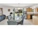 Open dining area connected to the kitchen and living space, with sliding doors to the backyard at 2658 Palmetto Ridge Cir, Apopka, FL 32712