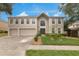 Charming two-story home with a well-manicured lawn and a three-car garage at 2658 Palmetto Ridge Cir, Apopka, FL 32712