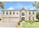 Stunning two-story home with a three-car garage, manicured lawn and beautiful front yard landscaping at 2658 Palmetto Ridge Cir, Apopka, FL 32712