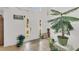 Bright and spacious foyer with tile flooring, plants, and a view of the outdoors at 2658 Palmetto Ridge Cir, Apopka, FL 32712