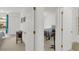Hallway with an open doorway leading into the light-filled main bedroom at 2658 Palmetto Ridge Cir, Apopka, FL 32712