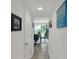 Hallway with tiled floor leading to dining area and backyard at 2658 Palmetto Ridge Cir, Apopka, FL 32712