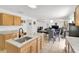 Open kitchen featuring granite countertops, an island, and a view into the dining and living areas at 2658 Palmetto Ridge Cir, Apopka, FL 32712