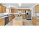 Spacious kitchen with stainless steel appliances, island, and light wood cabinets at 2658 Palmetto Ridge Cir, Apopka, FL 32712