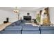 Spacious living room with a large sectional couch, ample lighting, and large windows at 2658 Palmetto Ridge Cir, Apopka, FL 32712