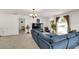 Bright living room features a large window and a comfortable blue sectional sofa at 2658 Palmetto Ridge Cir, Apopka, FL 32712