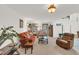 Comfortable living room with neutral paint, plush seating, and abundant natural light at 2658 Palmetto Ridge Cir, Apopka, FL 32712