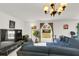 Inviting living room boasts a large window and elegant lighting fixture at 2658 Palmetto Ridge Cir, Apopka, FL 32712