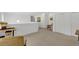 Bright loft with neutral carpeting, white walls, and artistic decor at 2658 Palmetto Ridge Cir, Apopka, FL 32712