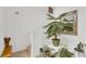 Entryway with staircase featuring tile flooring, greenery, and wall decor at 2658 Palmetto Ridge Cir, Apopka, FL 32712