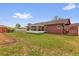 View of the backyard with a covered patio, grassy area, shed, and fence at 2665 E Juliet Dr, Deltona, FL 32738