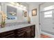 Bathroom featuring a double sink vanity, marble countertop, chandelier, and glass door shower at 2665 E Juliet Dr, Deltona, FL 32738