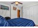 Bedroom featuring a TV, closet, ceiling fan, and a bed with a blue bed set at 2665 E Juliet Dr, Deltona, FL 32738