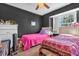 Bright bedroom features two beds, ceiling fan, and a large window for natural light at 2665 E Juliet Dr, Deltona, FL 32738