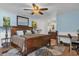 Light blue bedroom featuring a ceiling fan, wooden floors, a comfortable bed, and workspace at 2665 E Juliet Dr, Deltona, FL 32738