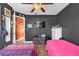 Cozy bedroom with a TV, two twin beds, dark walls and contrasting bright orange hallway at 2665 E Juliet Dr, Deltona, FL 32738