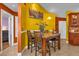 Stylish dining area with a marble-topped table and seating for four, enhanced by vibrant yellow walls at 2665 E Juliet Dr, Deltona, FL 32738